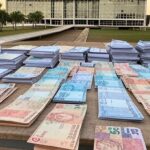 Congresso Nacional em Brasília com documentos simbólicos de emendas orçamentárias de R$ 61 bi e cortes sociais para 2026.
