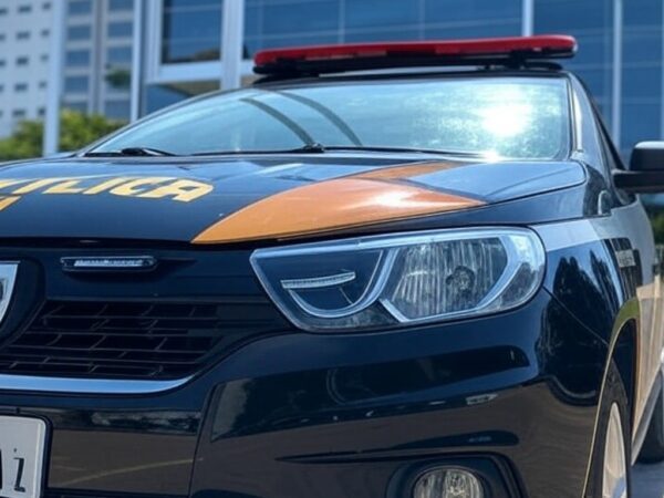 Viatura da Polícia Federal em frente a prédio de banco no Brasil, representando investigação de fraudes na venda do Banco Master.