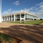 Vista do Palácio do Planalto em Brasília com bandeira brasileira, representando a corrida presidencial de 2026.