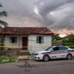 Casa em Jataí isolada por fita policial e viatura da PM, representando cena de crime após separação violenta.